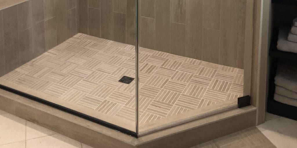 Shower Pans Tile Vs Solid Surface, How To Lay A Tile Shower Floor